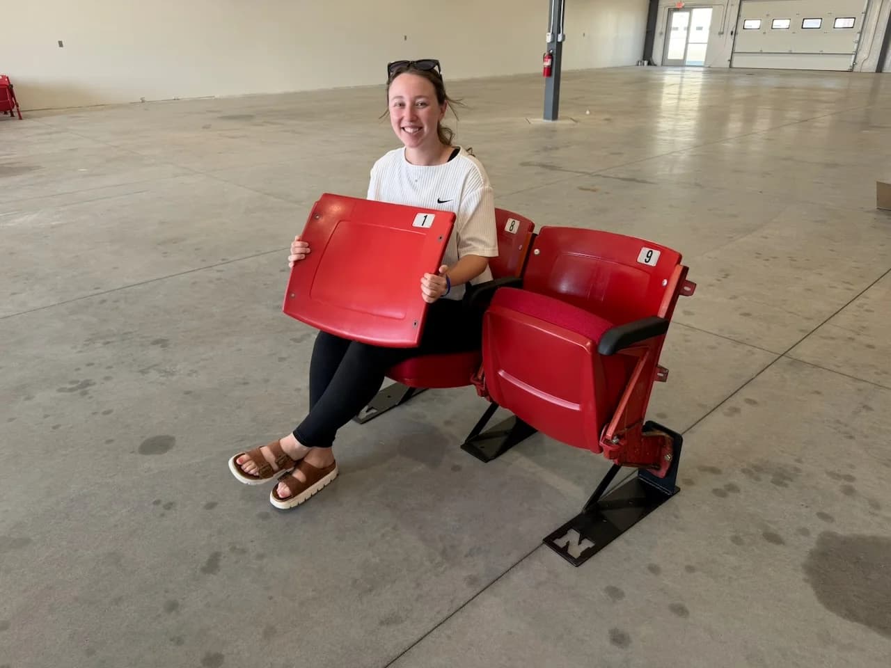 Happy Husker fan with her Nebraska bench seats at pickup
