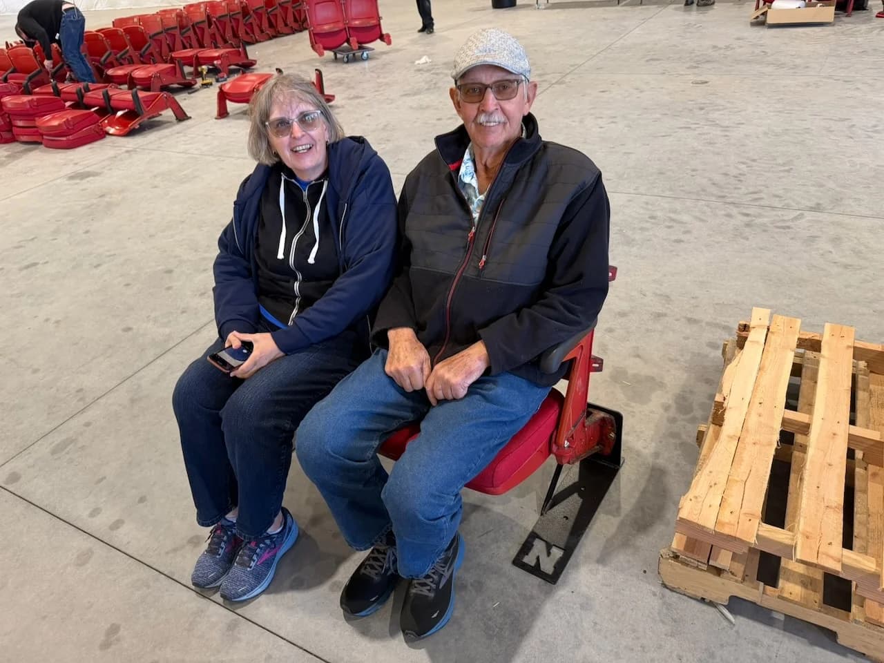 Husker fans couple sitting on their Nebraska bench seats at pickup